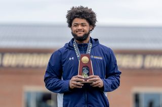 Ancil Alexander pictured with his All-American medal and trophy at the 2026 Track & Field National Championships