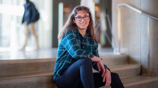 Student sitting on steps in Library