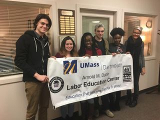 Interns holding a banner