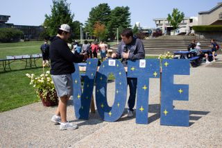 Student Christopher Wornham helping students register to vote.