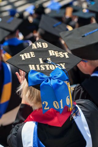 Student's decorated graduation cap that says 