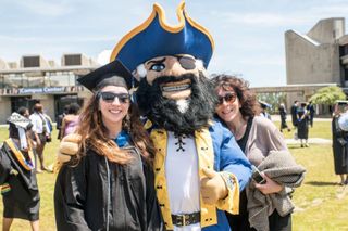 Students and Arnie at commencement