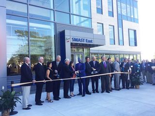 Group of people cutting ribbon at SMAST East 2017