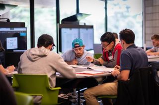 Male students working in a new workstation in SENG