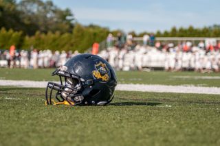 Football helmet sitting on a football field