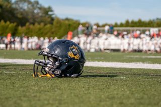 Football helmet sitting on a football field