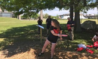 Student playing disc golf
