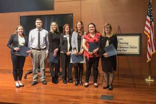 Undergraduate and graduate nursing poster contest winners with Dean Christopher