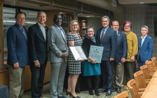 University officials posing with citation