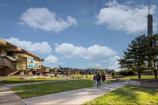 UMass Dartmouth campus quad with students walking