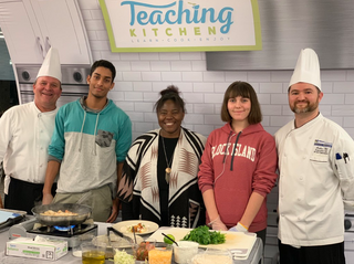 Chef and students at cooking demonstration
