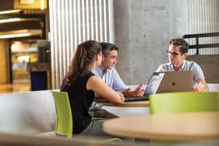 Students speaking with a professor
