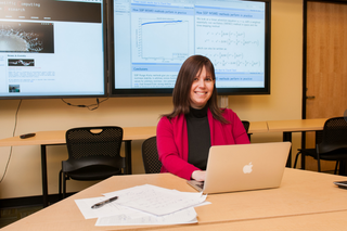 Professor Sigal Gottlieb sitting at desk with laptop