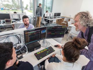 Professor and students at Bloomberg terminal