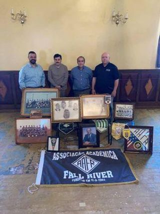 Donated items to Archive and staff members posing