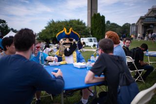 Arnie sitting with students at convocation