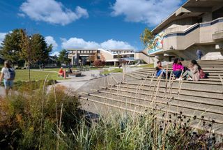 students sitting on steps at quad