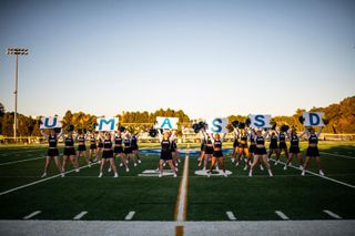UMassD Corsair Cheerleaders on the football field