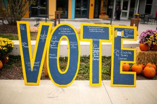 UMassD Blue and Yellow Vote Sign