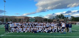 UMassD Corsairs Football Team MASCAC Champs posing on field