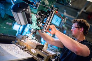 Student working with machinery in engineering lab