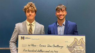 Seniors Christian Fall (left) and Dylan Cantara (right) pose with their ceremonial first-place check