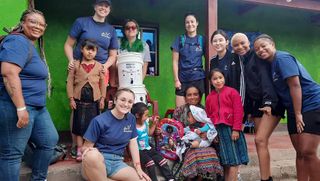 UMassD students pose with local Guatemalans during their alternative spring break