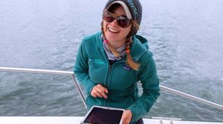 SMAST PhD student Megan Winton on a boat conducting research on Cape Cod