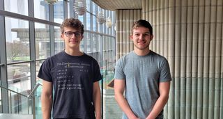 Students and SMART scholarship winners Chris Brunette and James Bourgeois stand side by side in the library