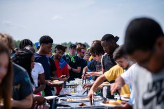 students grabbing food during picnic