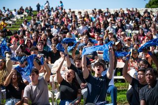 students wave bandanas at new student convocation