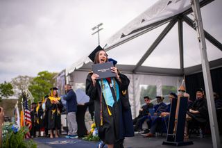 student crossing the graduation stage