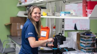 Dr. Lauran Brewster in her lab with the acoustic receivers that will be used in her research
