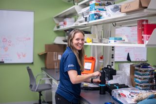 Dr. Lauran Brewster in her lab with the acoustic receivers that will be used in her research