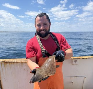 Dr. Nicholas Calabrese holding an Atlantic halibut