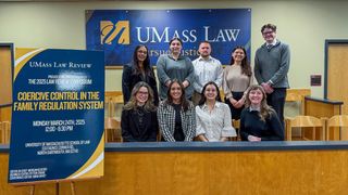 Members of the executive board of the UMass Law review pose in the Moot Court Room.