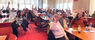 Group of faculty particpating in an event in the Claire T Carney library