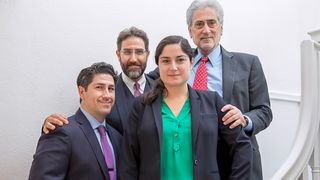 Father, two sons, and daughter standing together