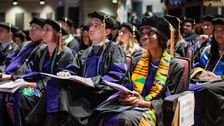 Law students sitting in a row in Main Auditorium