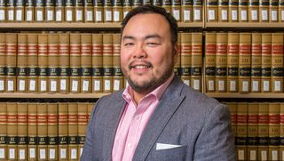 Law professor standing in front of bookcases