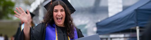 UMassD student at commencement waving