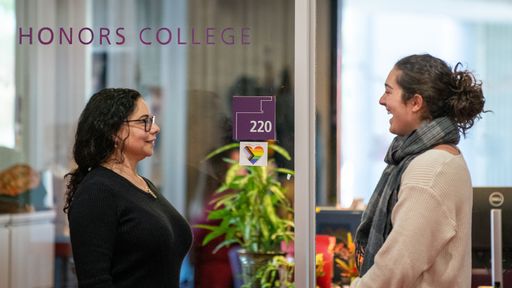 Amy Shapiro and Fiona Marques '25: Integrated Studio Arts, Psychology majors) standing outside of the Honors College Office