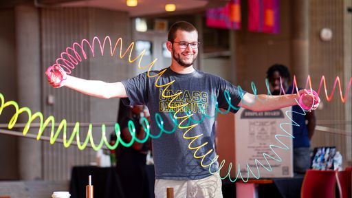 Student demonstrating a physics concept with slinkys