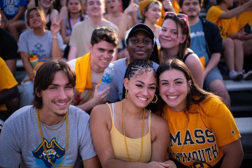Group of students at a UMassD football game in the bleachers