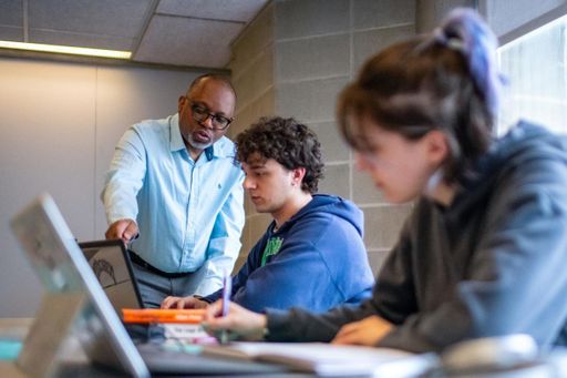 UMassD faculty assisting students in class