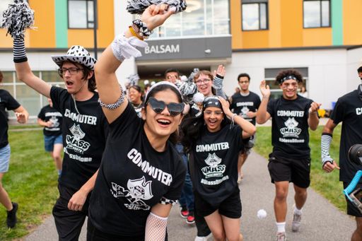 Group of students running towards the camera at Corsair Olympics campus event.