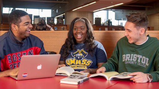 UMassD students laughing together in the library study area