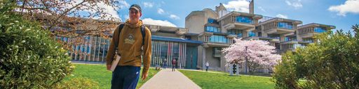 Student walking outside of Claire T. Carney Library