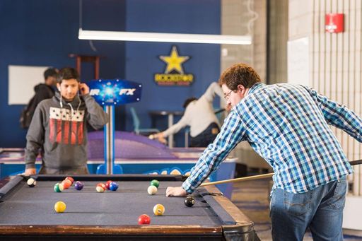Students shooting pool in the Campus Center's game room. 