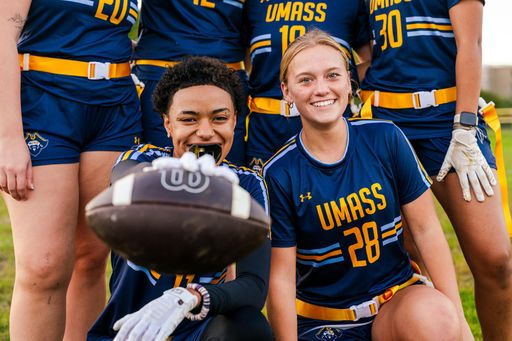 Women's Flag Football at UMass Dartmouth group photo holding up football